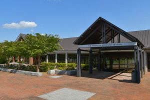 front of dark building with paved entry