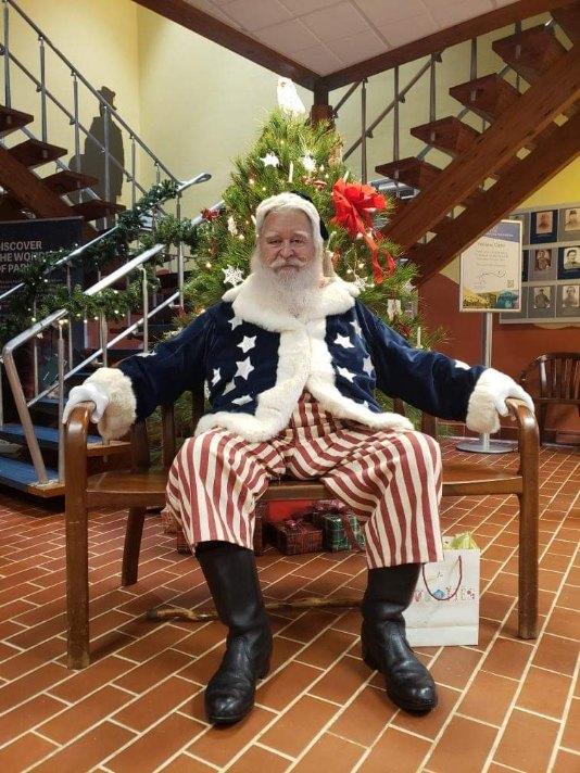 Man with white beard dressed in Civil War Santa outfit