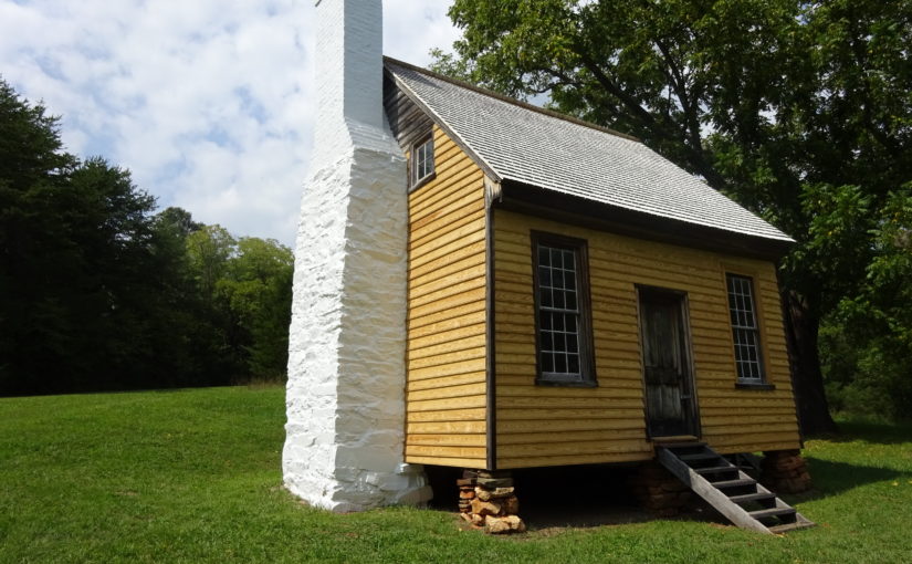 small cabin with white brick chimney