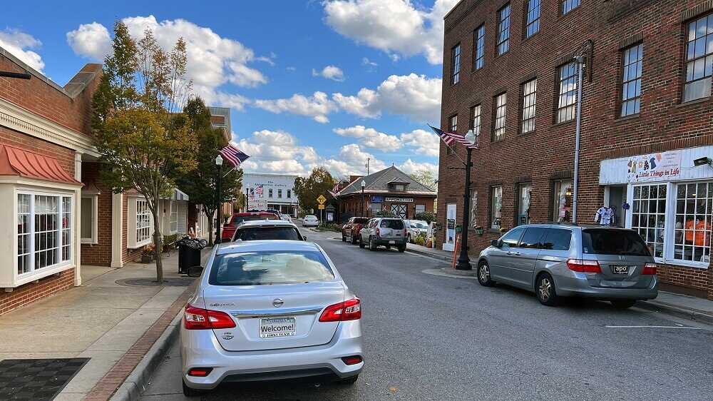 Cars parked outside brick buildings in downtown area