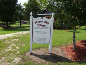 wooden sign for clover hill village