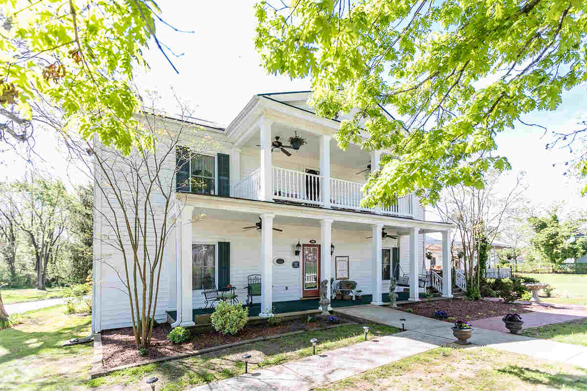 Front of white building with porch