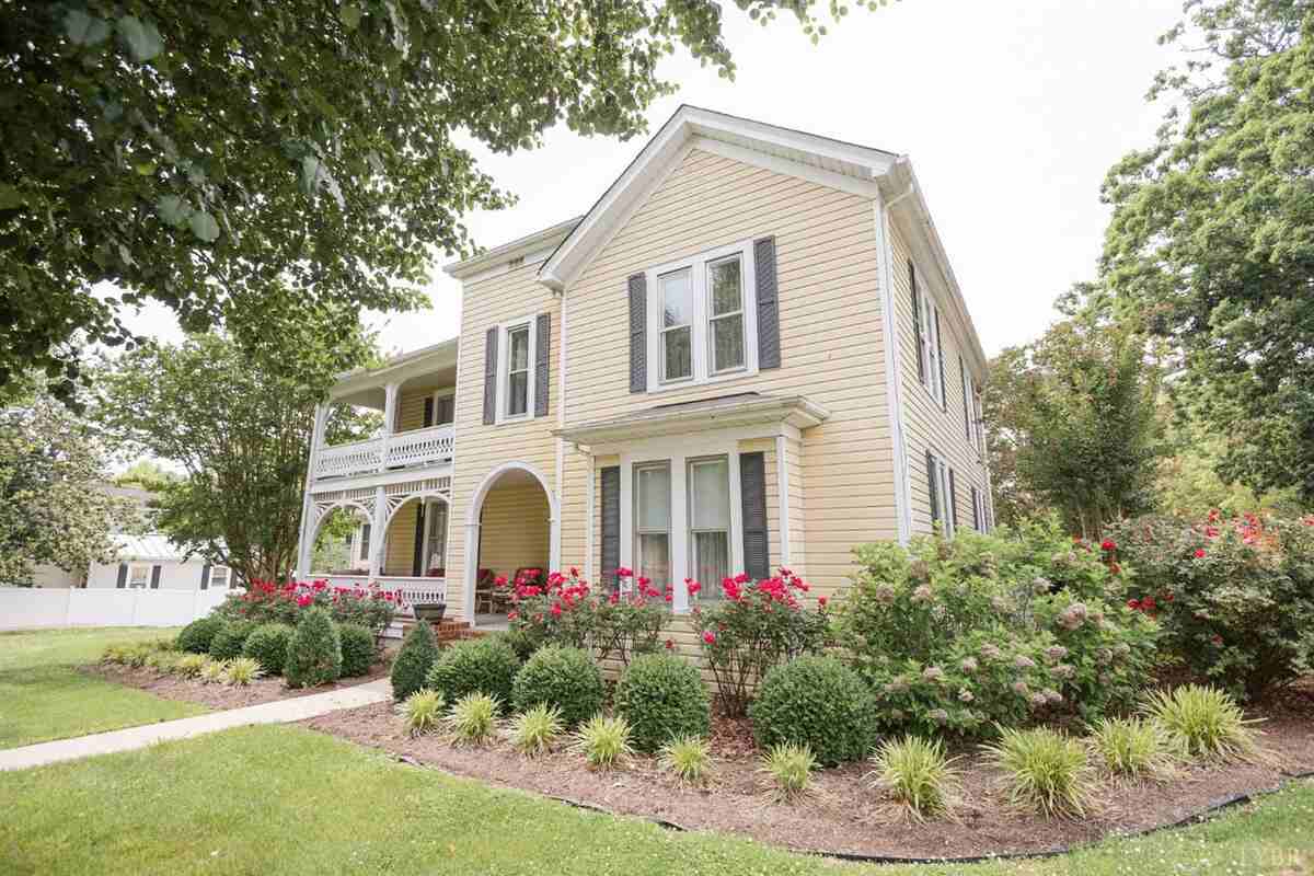 Yellow house with flower garden