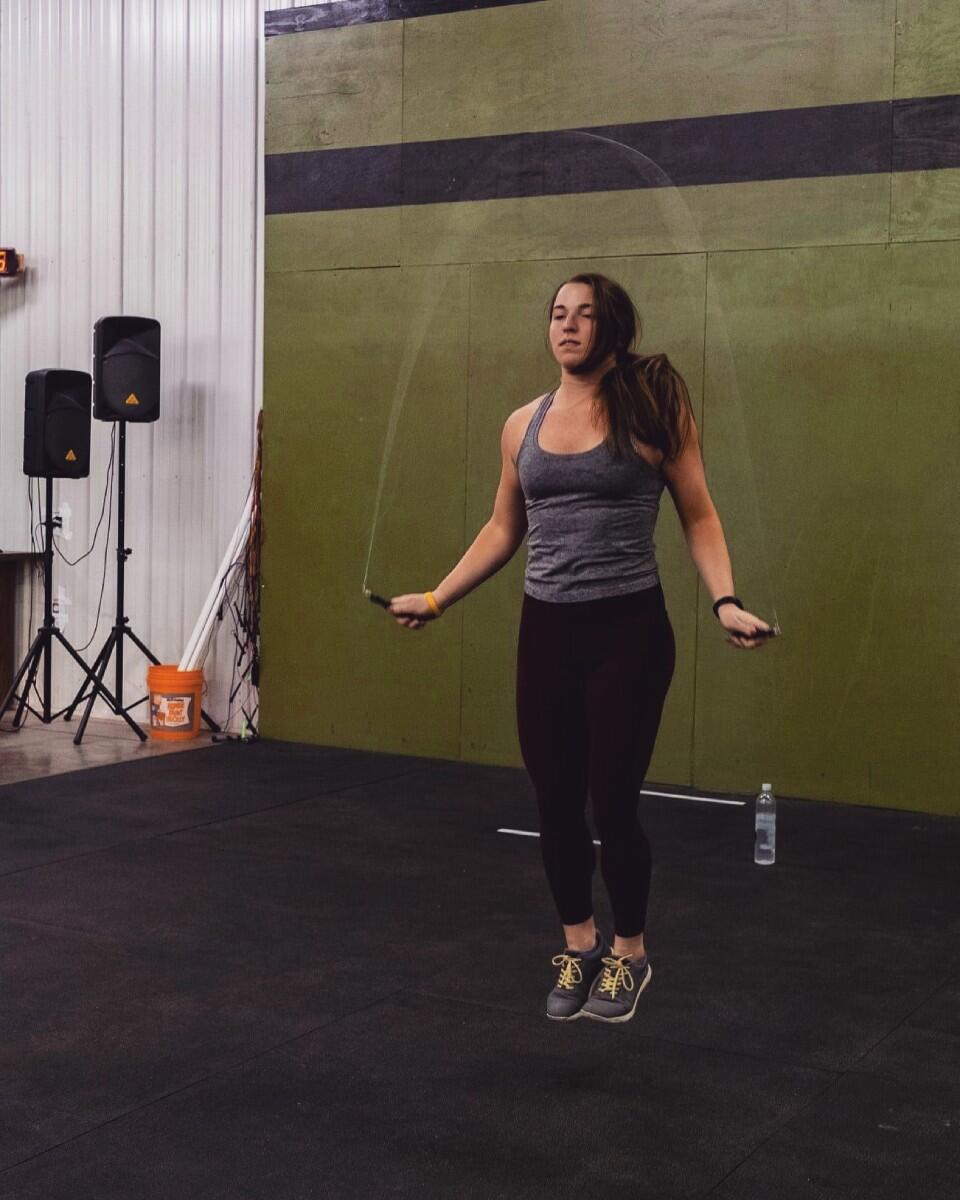 Woman jumping rope in gym