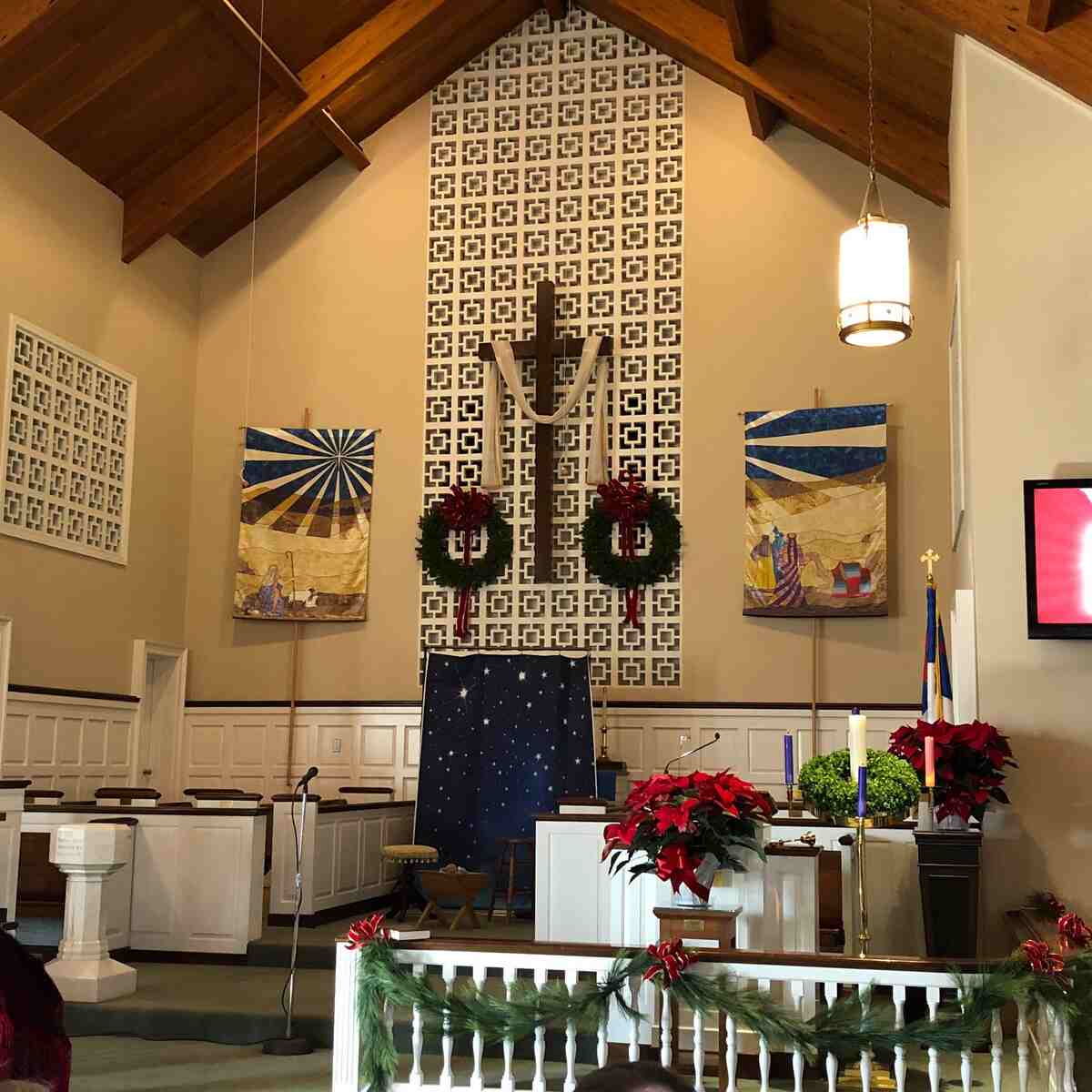 Interior of church decorated with wreaths and green boughs