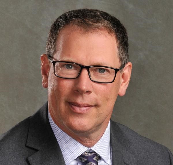 Man with short hair and glasses