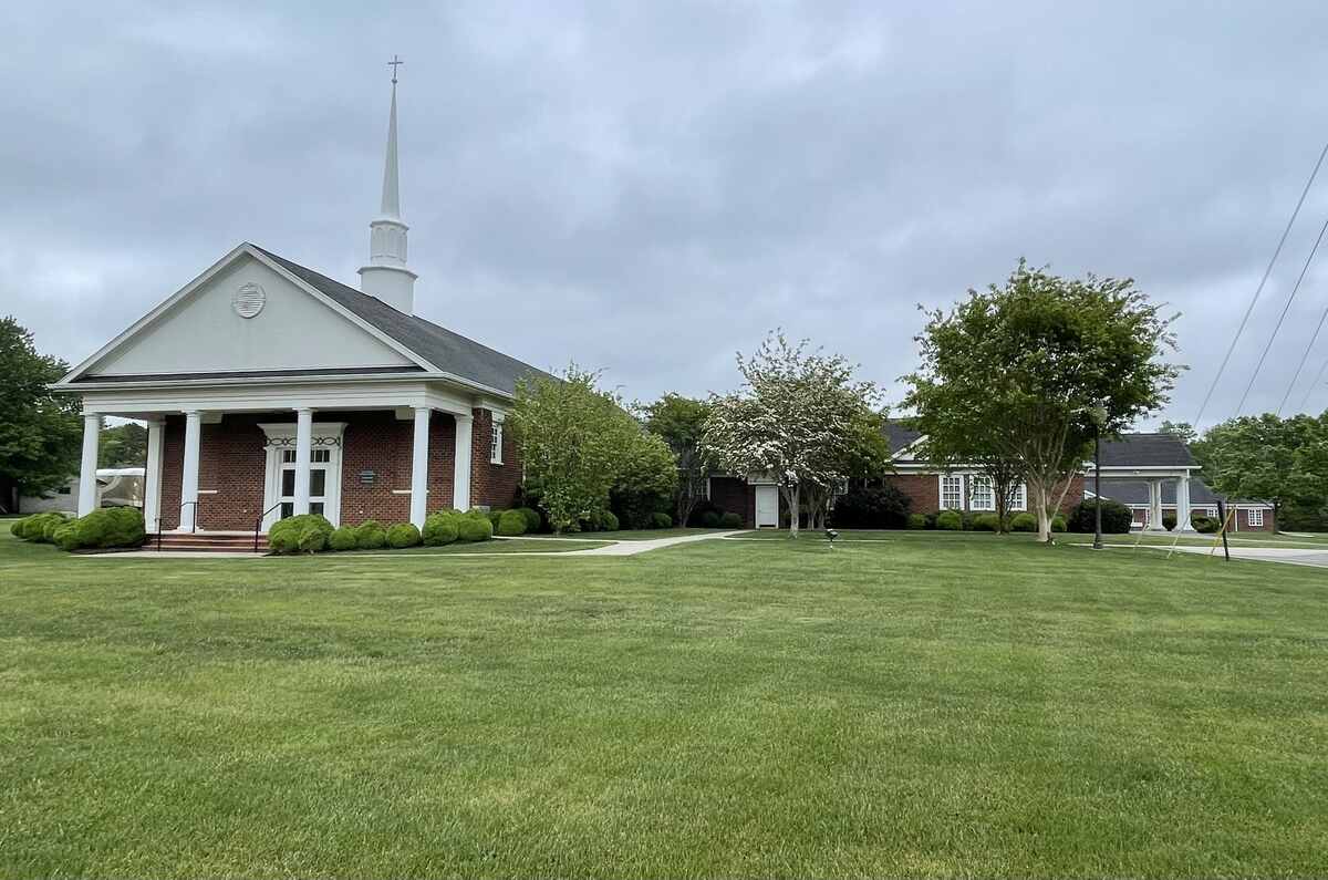 Brick church with big lawn and trees