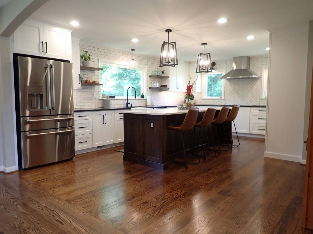 White kitchen with island and wood floor