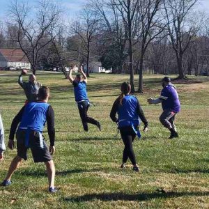 Group of people playing football in field