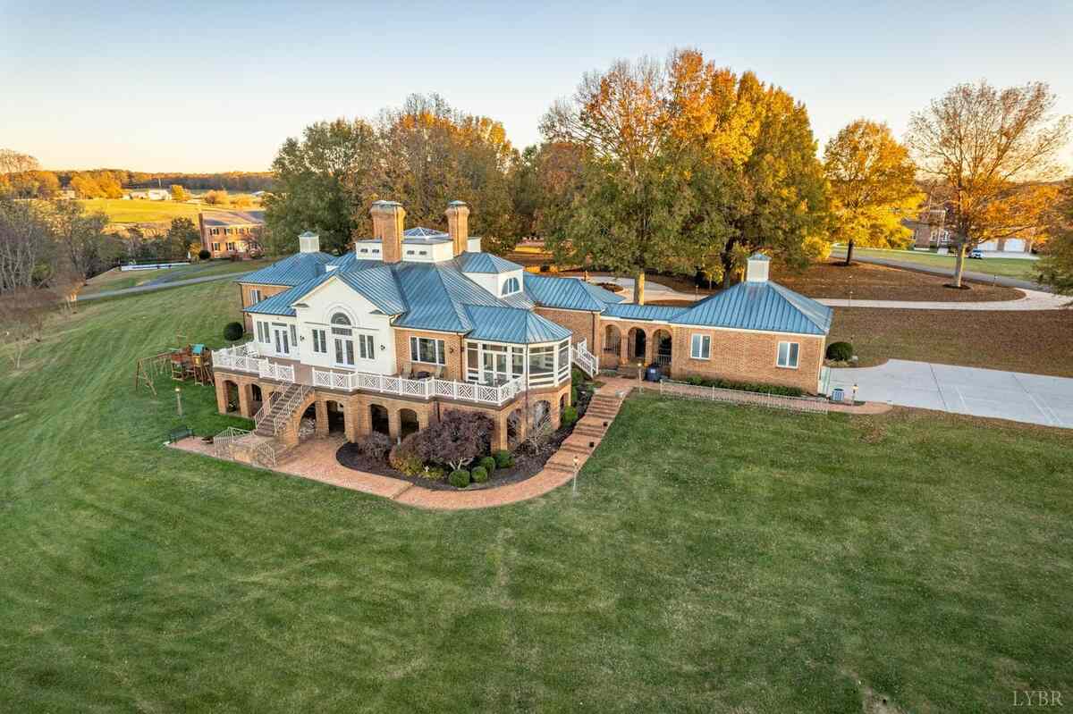 large brick house with manicured lawn