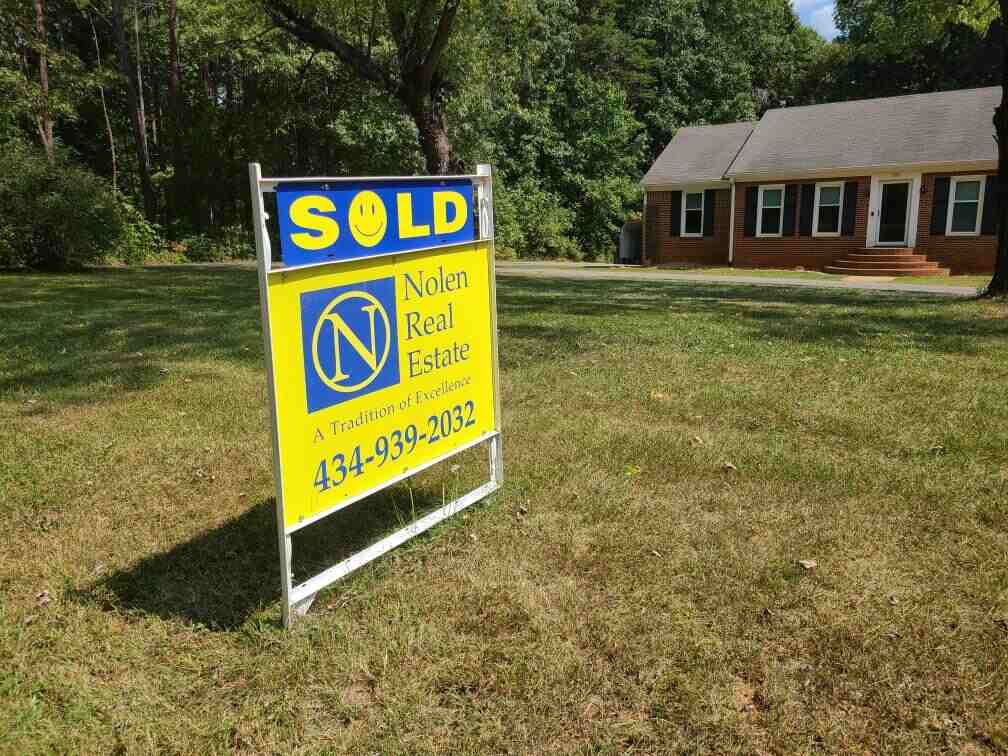 Brick house with SOLD sign
