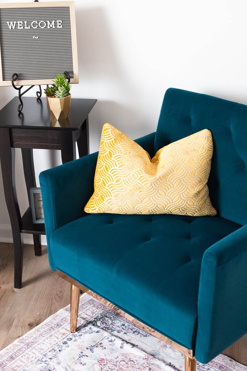 Blue chair with yellow pillow