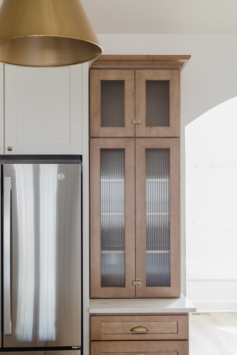 kitchen cabinet next to fridge