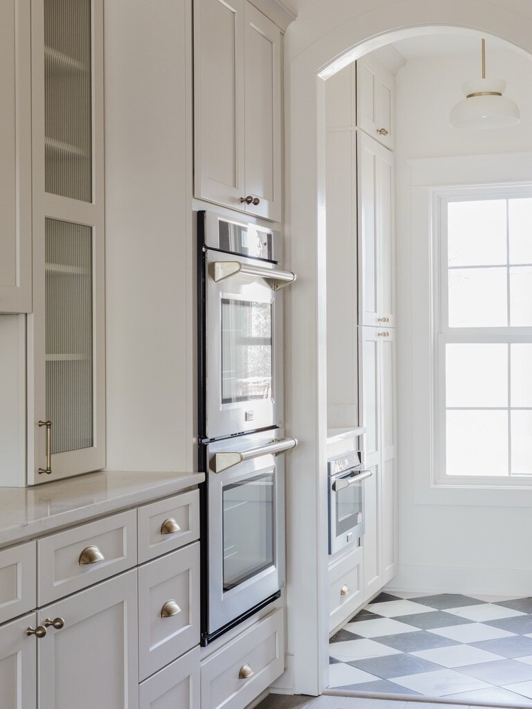 White kitchen with black and white checkerboard floor