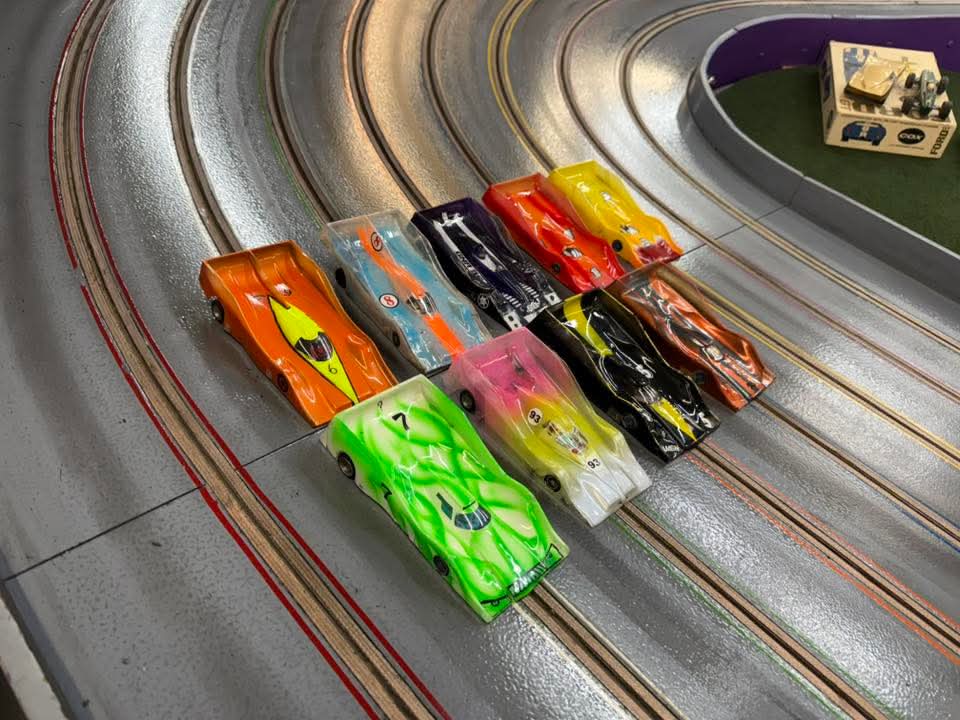 Toy racecars lined up on track