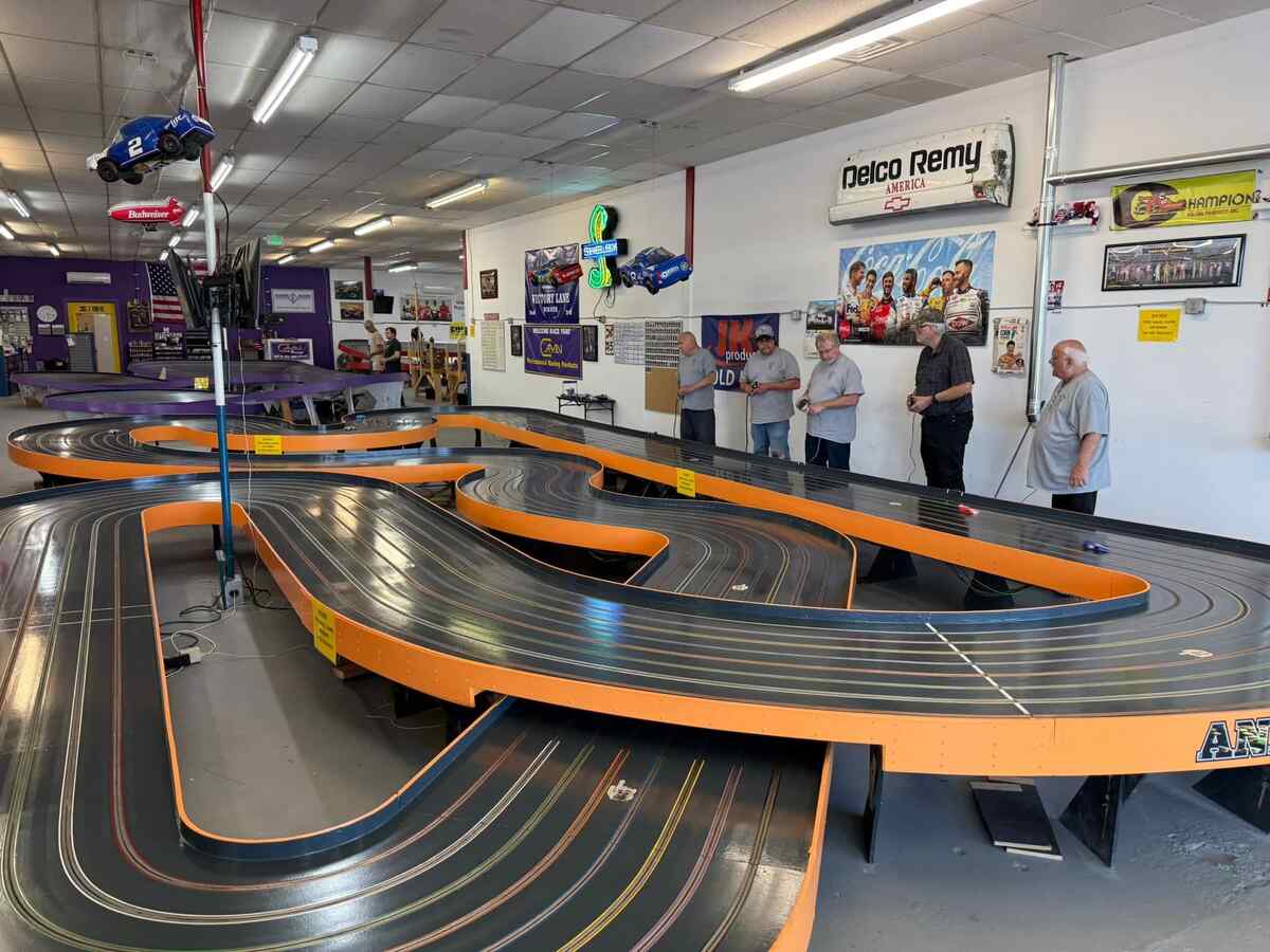 Toy racecar track with five men.