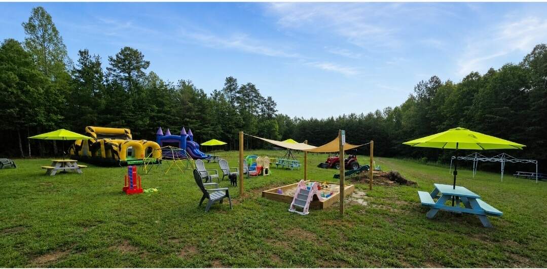 Brightly colored playground with picnic tables and umbrellas