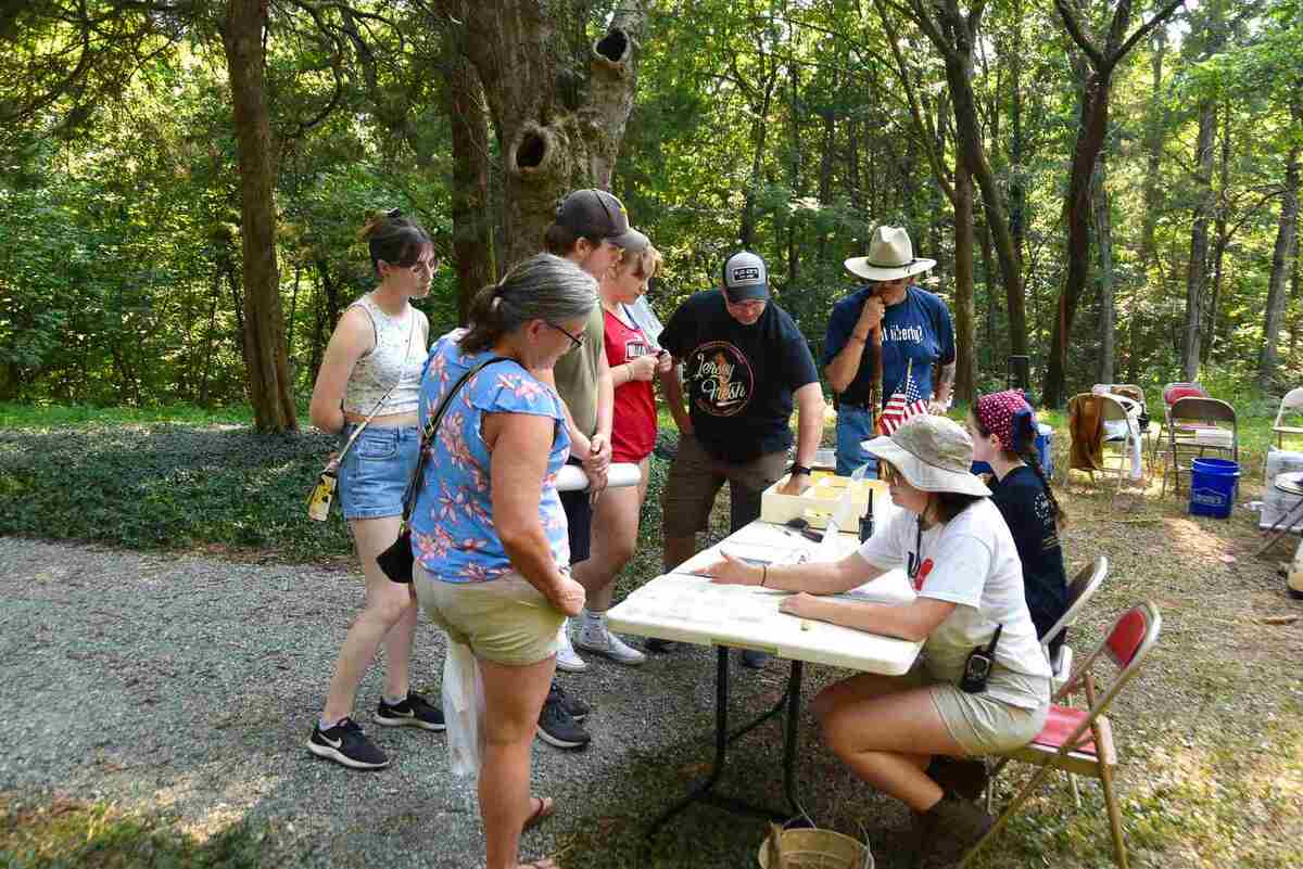 Table with group of people surrounding it.