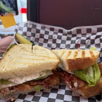 Sandwich cut in half on black and white paper
