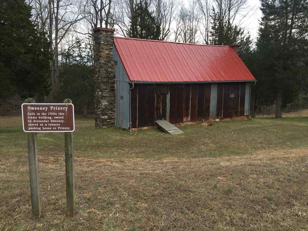 red roofed cabin with historical marker