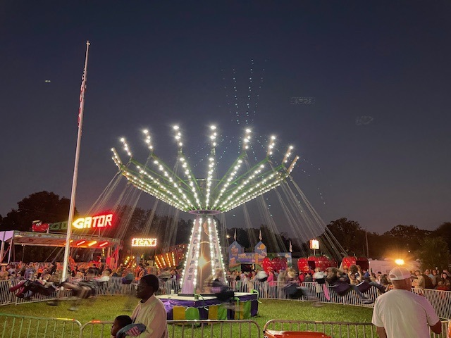 rides in the lights at night at carnival