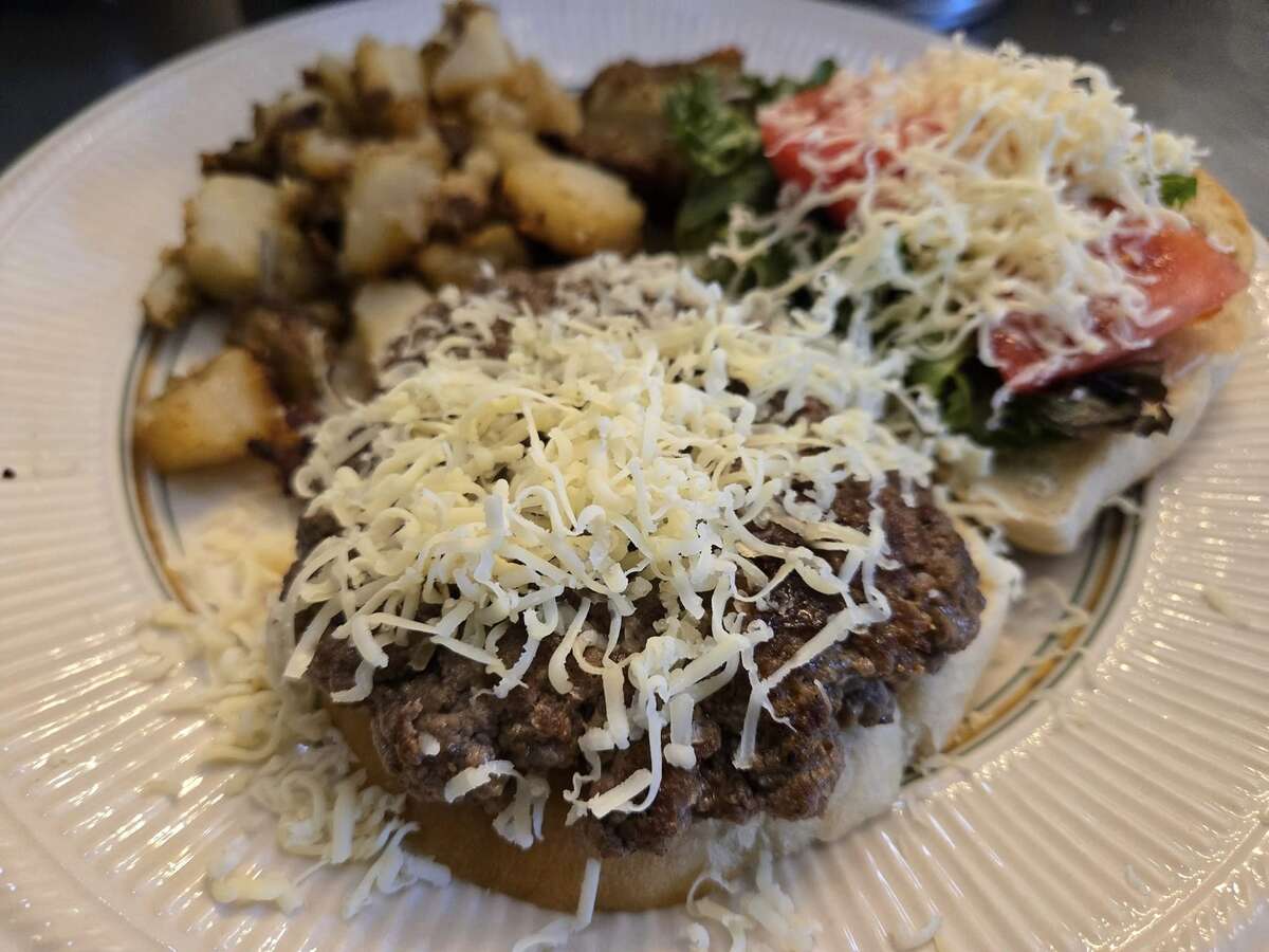 plate of food containing burger sprinkled with cheese