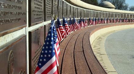 flags next to memorial wall