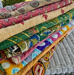 stack of colorful quilts