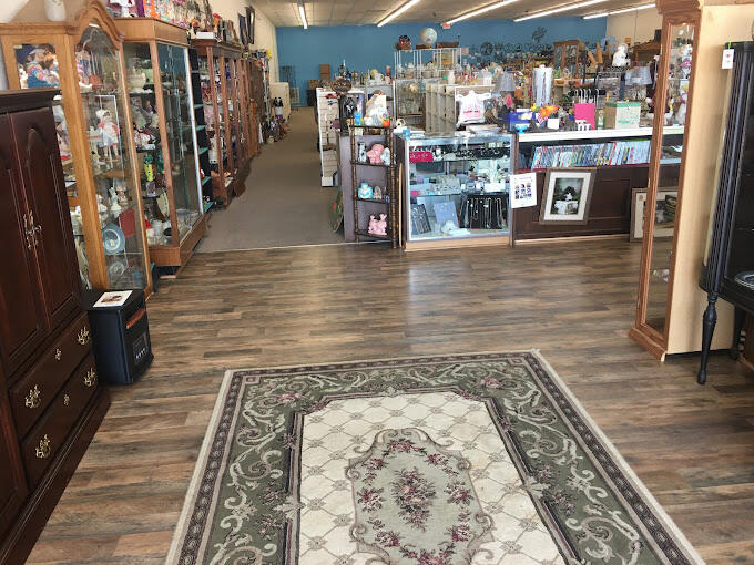 large room with rug and shelves of items